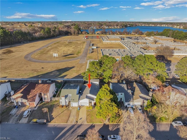 birds eye view of property with a water view and a residential view