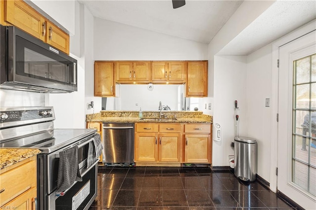 kitchen featuring baseboards, vaulted ceiling, stainless steel appliances, granite finish floor, and a sink