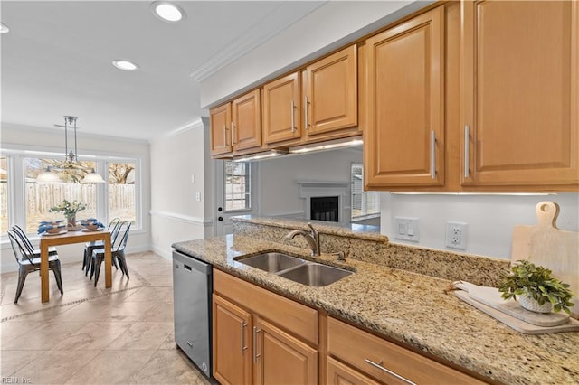 kitchen featuring a sink, ornamental molding, stainless steel dishwasher, light stone countertops, and decorative light fixtures