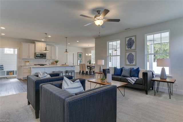 living area with visible vents, baseboards, a ceiling fan, and recessed lighting