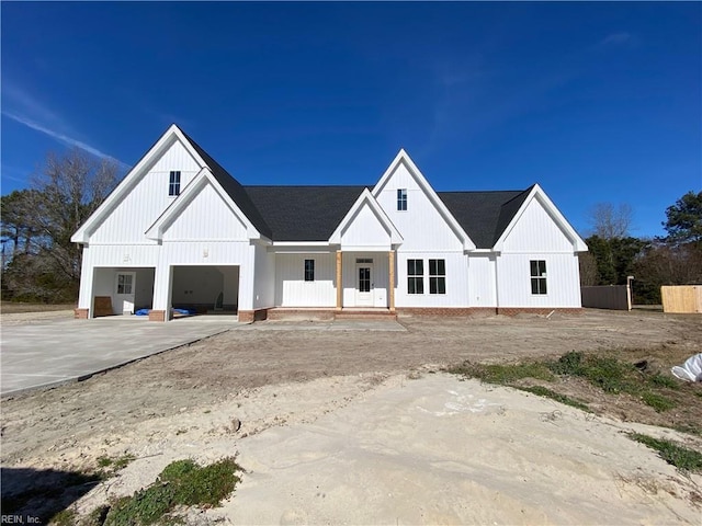 modern farmhouse featuring a garage and driveway