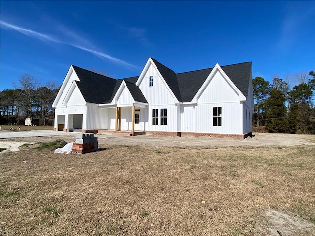 modern farmhouse style home with a front yard