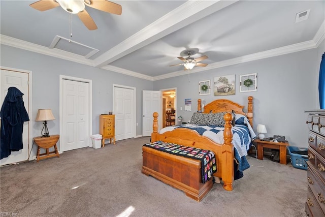 carpeted bedroom featuring a ceiling fan, multiple closets, visible vents, and crown molding