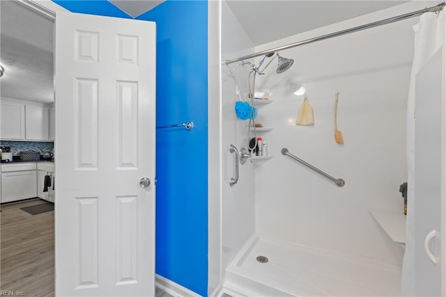 bathroom with tasteful backsplash, wood finished floors, and a shower with curtain