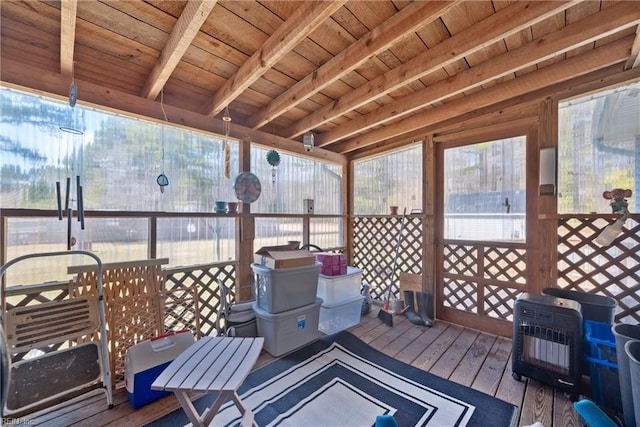 wooden terrace with outdoor dining space and heating unit