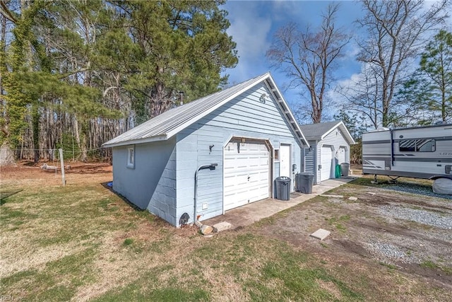 detached garage featuring fence