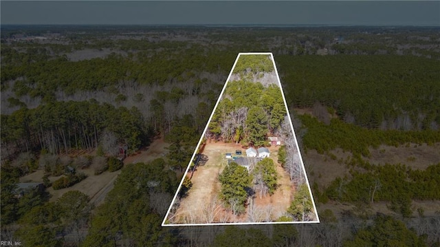 birds eye view of property featuring a wooded view