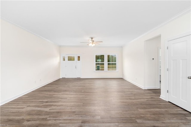 unfurnished room with ceiling fan, baseboards, wood finished floors, and crown molding