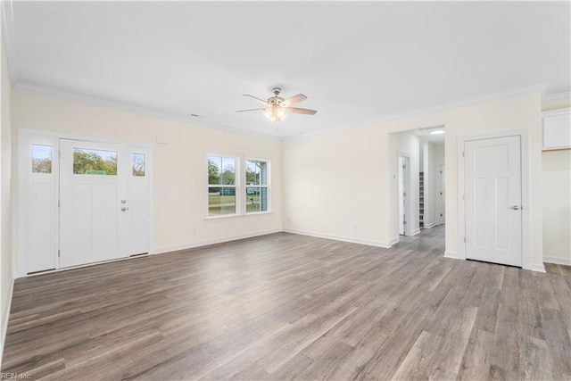 unfurnished living room with ornamental molding, light wood-style floors, baseboards, and ceiling fan