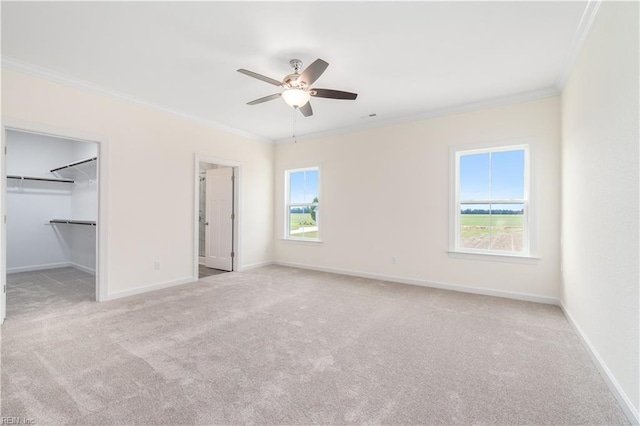 unfurnished bedroom with carpet flooring, crown molding, and baseboards