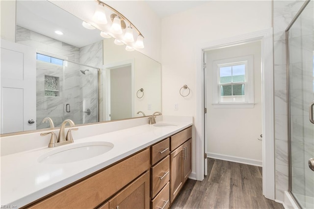 bathroom featuring a wealth of natural light, a sink, and a stall shower