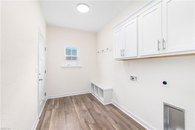 washroom with cabinet space, baseboards, light wood-style flooring, washer hookup, and electric dryer hookup