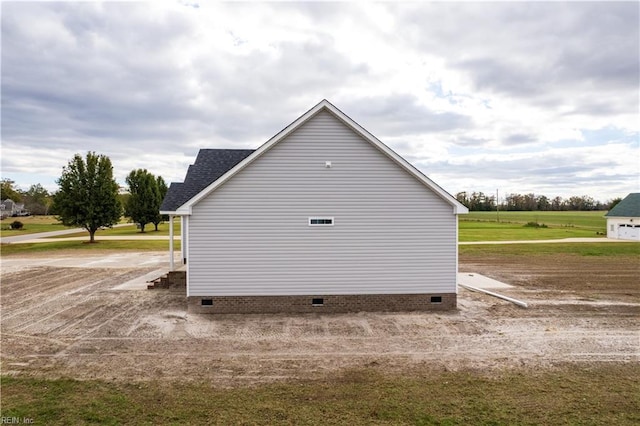 view of property exterior featuring a shingled roof and crawl space