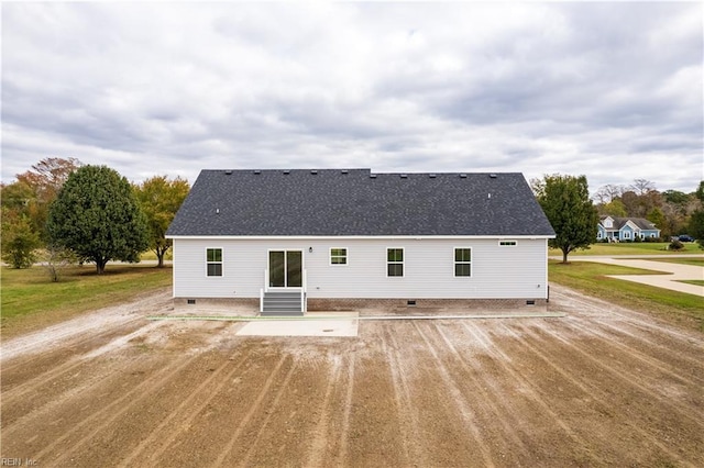 rear view of house with crawl space, a shingled roof, and entry steps