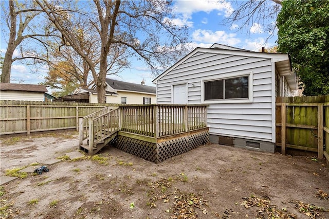 rear view of house featuring crawl space, a fenced backyard, and a deck