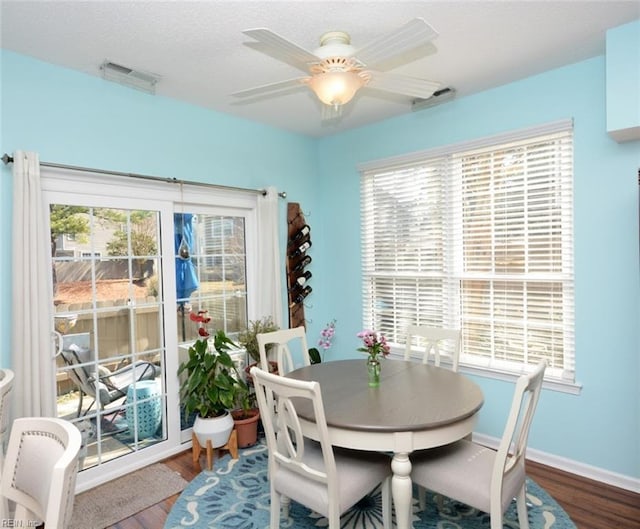 dining space with visible vents, a wealth of natural light, and wood finished floors