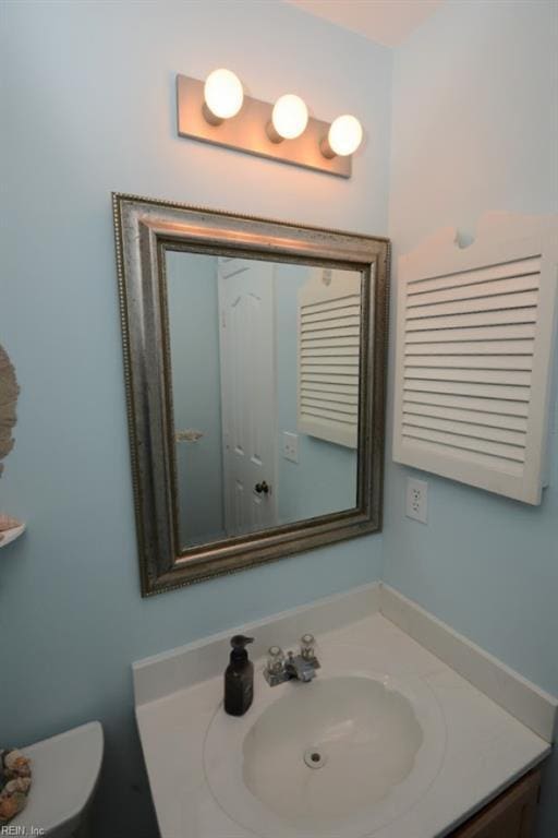 half bath with vanity and toilet