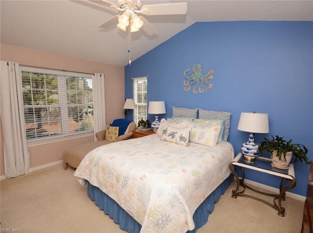 carpeted bedroom with lofted ceiling, a ceiling fan, and baseboards