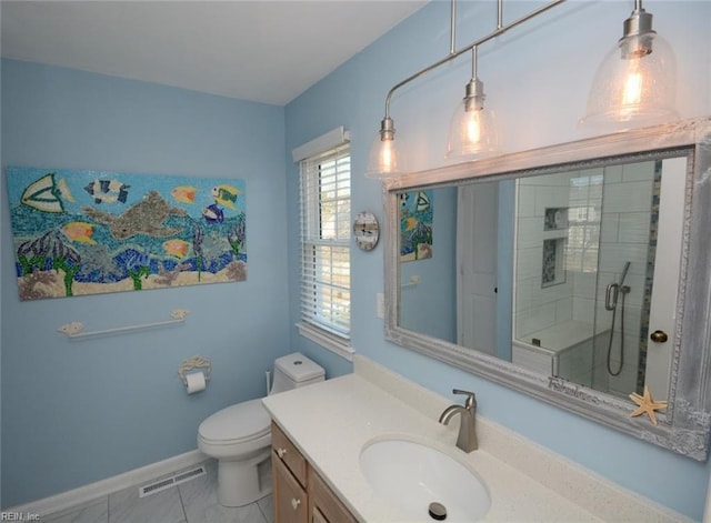 full bathroom featuring toilet, vanity, visible vents, baseboards, and a shower stall