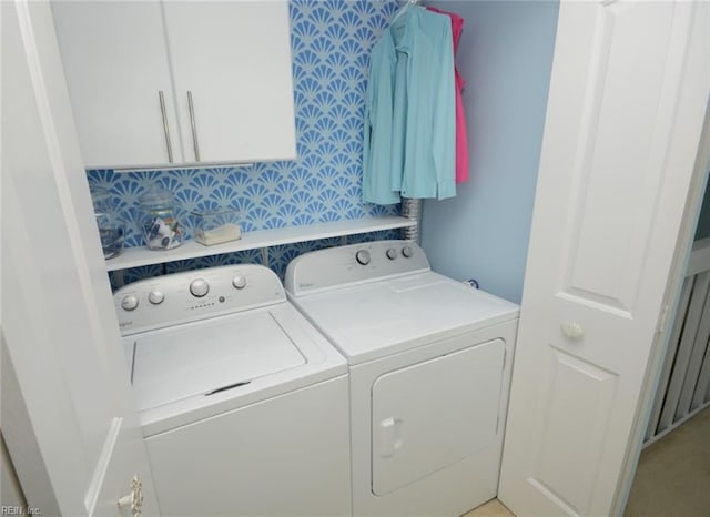 laundry room with cabinet space and washer and clothes dryer