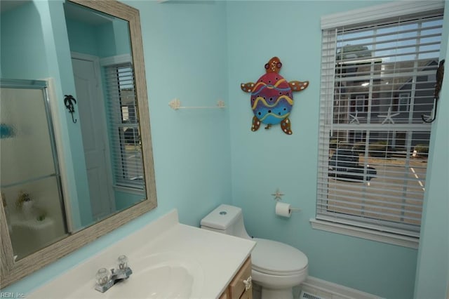 full bath featuring toilet, baseboards, an enclosed shower, and vanity