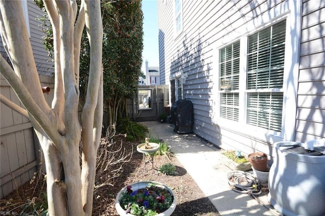 view of home's exterior featuring a patio area and fence