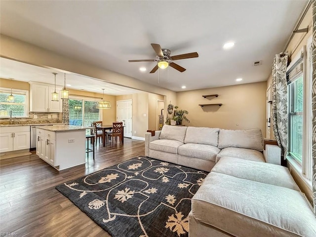 living room with ceiling fan, dark wood-type flooring, baseboards, and recessed lighting