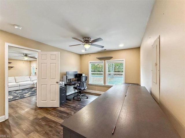 office featuring ceiling fan, dark wood-type flooring, visible vents, and baseboards