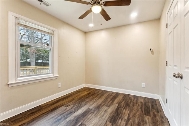 empty room with recessed lighting, visible vents, dark wood finished floors, and baseboards