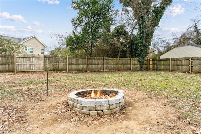 view of yard featuring an outdoor fire pit and a fenced backyard