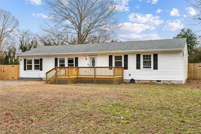 view of front of home with a deck, a front lawn, crawl space, and fence