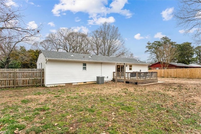 back of property with a deck, a lawn, cooling unit, and a fenced backyard