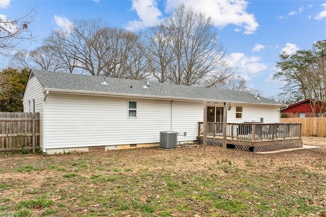 rear view of property featuring a shingled roof, central AC unit, crawl space, fence, and a wooden deck