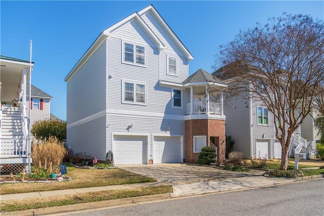 view of front of home with a garage, brick siding, driveway, and stairs