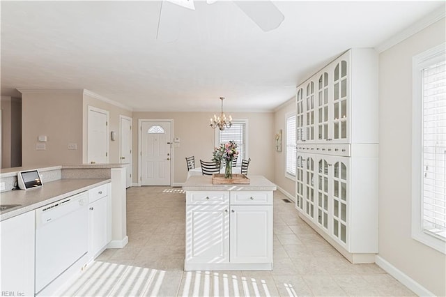 kitchen featuring white dishwasher, a notable chandelier, white cabinetry, baseboards, and light countertops