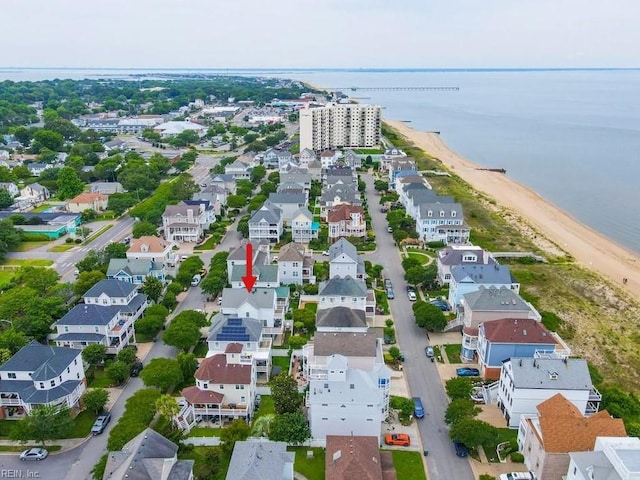 drone / aerial view with a water view, a residential view, and a beach view