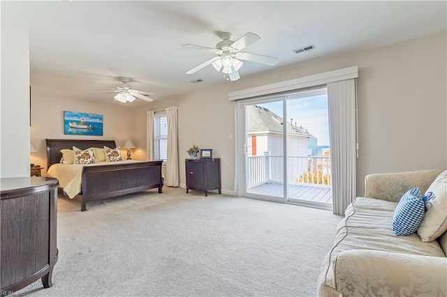 bedroom featuring access to exterior, light colored carpet, visible vents, and ceiling fan