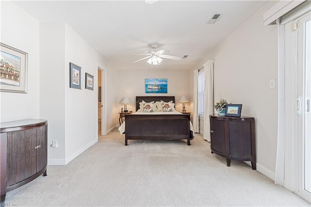 carpeted bedroom with a ceiling fan, multiple windows, visible vents, and baseboards