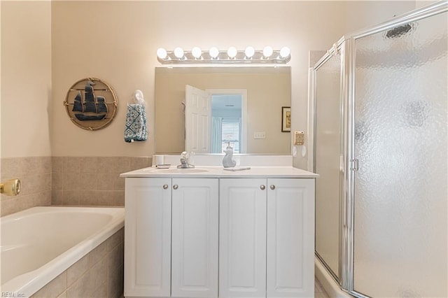 full bath with a garden tub, vanity, and a stall shower