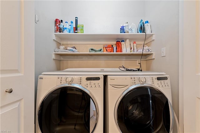 clothes washing area with laundry area and washer and clothes dryer