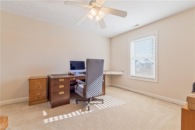 carpeted office with a ceiling fan, visible vents, and baseboards