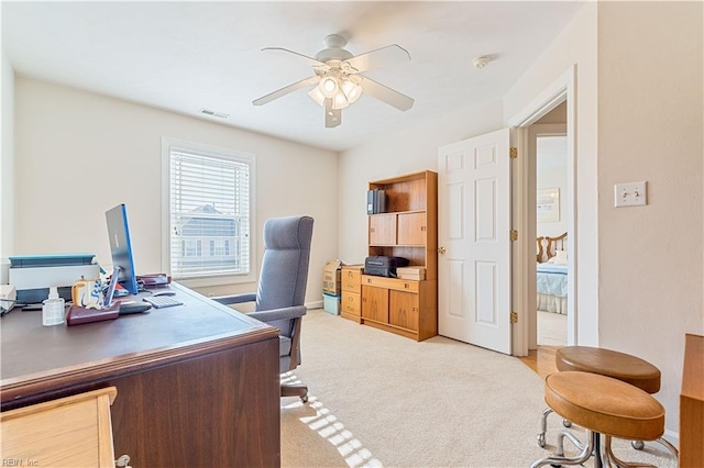 office with light carpet, ceiling fan, and visible vents