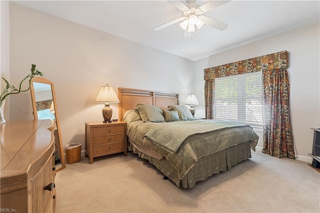 bedroom with light carpet, ceiling fan, and baseboards