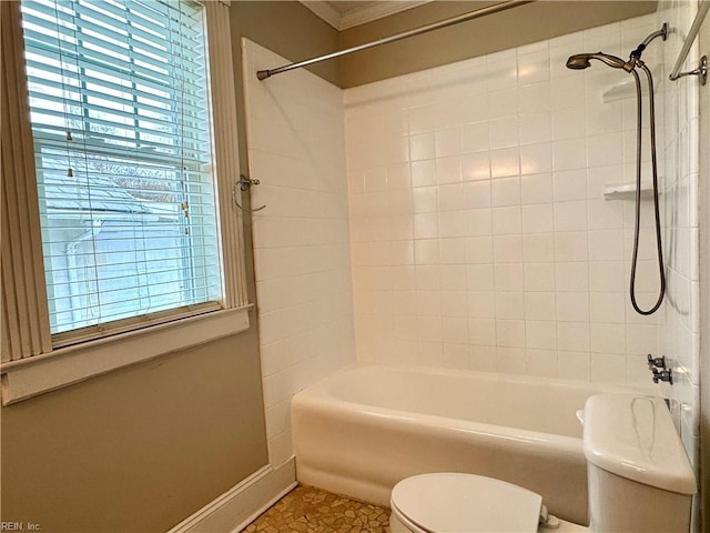 full bath featuring toilet, plenty of natural light, baseboards, and shower / bathtub combination