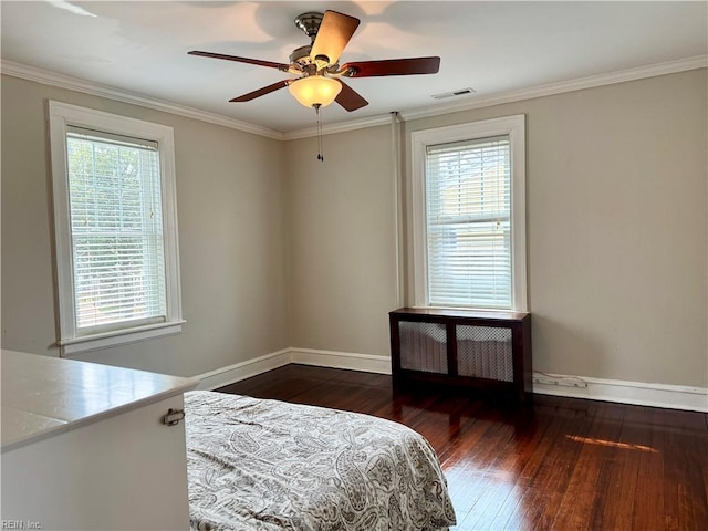 bedroom with baseboards, visible vents, hardwood / wood-style flooring, radiator heating unit, and ornamental molding