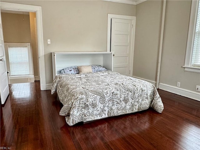 bedroom with wood finished floors and baseboards