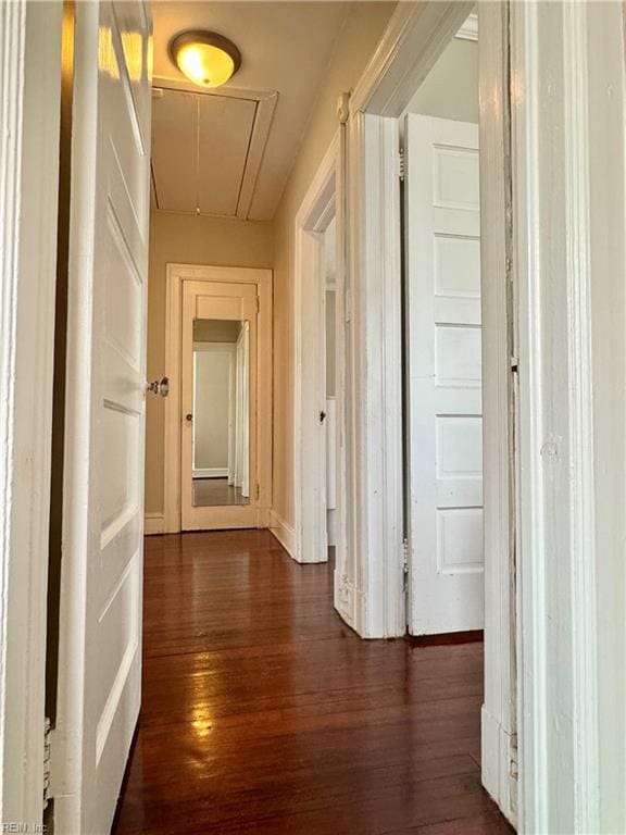 hall with dark wood-style floors and attic access