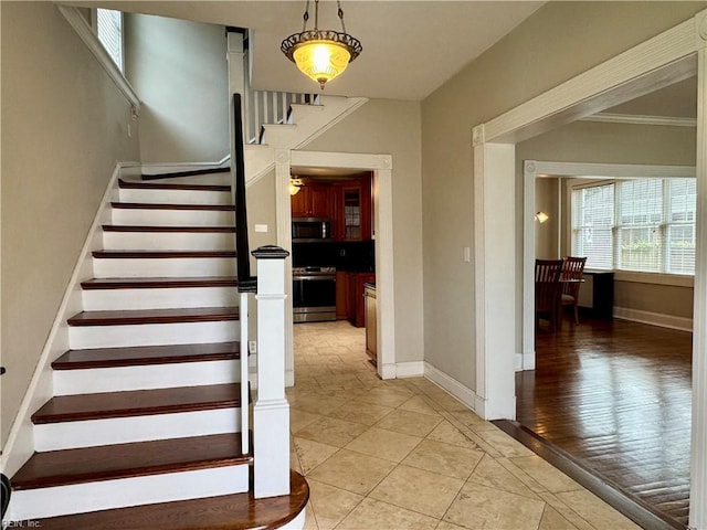 stairway with baseboards and tile patterned floors