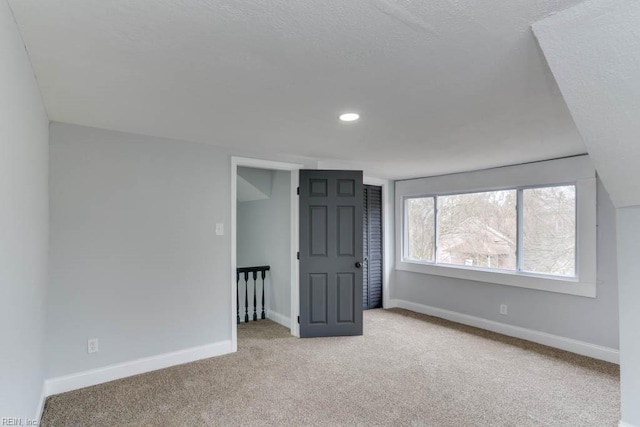 unfurnished room with recessed lighting, carpet flooring, and baseboards