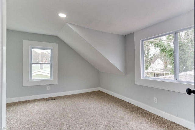 additional living space with lofted ceiling, recessed lighting, carpet floors, visible vents, and baseboards